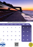 Calendar with a scenic view of a train track by a body of water at sunset, featuring the GWR IET logo.